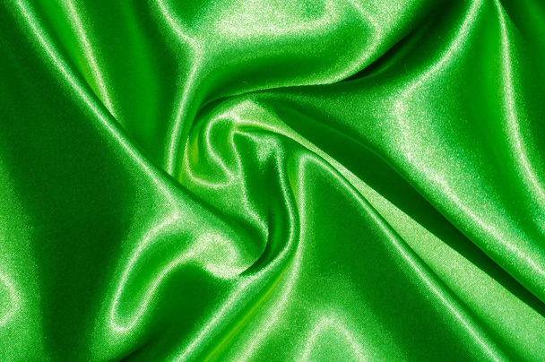 Texture, fabric, background. Abstract background of luxurious fabric or liquid waves or wavy grunge crease silk satin texture of velvet material or luxurious Christmas or elegant background. green - Фото, зображення