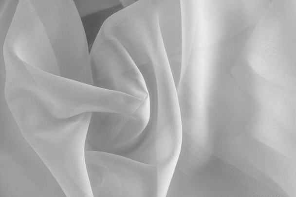 Texture, background, pattern. Silk fabric is transparent, white in color. Abstract soft chiffon texture background. Soft white chiffon with curve and wave - Photo, Image