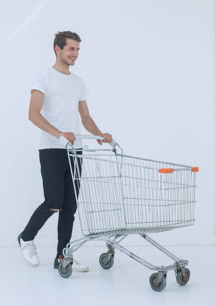 smiling man pushing shopping cart. - Φωτογραφία, εικόνα