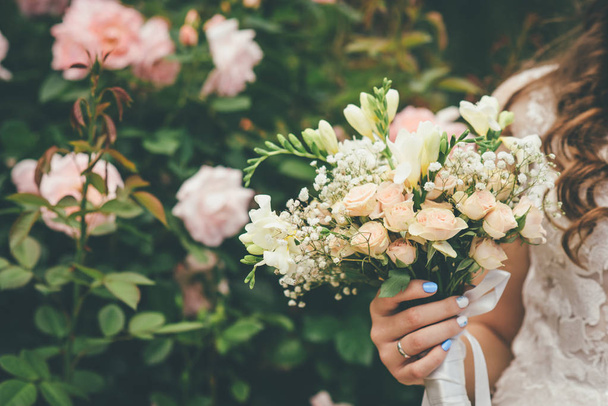 woman is holding wedding bouquet - Photo, Image