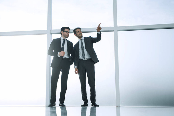 background image.two businessmen point to a copy of the space - Foto, Bild
