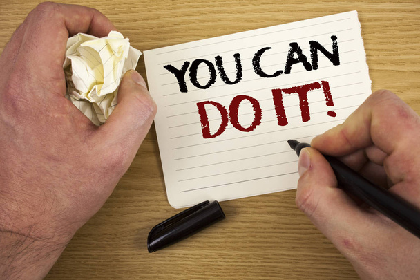 Handwriting text You Can Do It Motivational Call. Concept meaning Inspirational Message Motivational Positive Text two words white paper note black marker hand crumbled paper note - Photo, Image