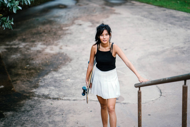 Portrait of Asian Chinese girl with skate in skatepark - Fotó, kép