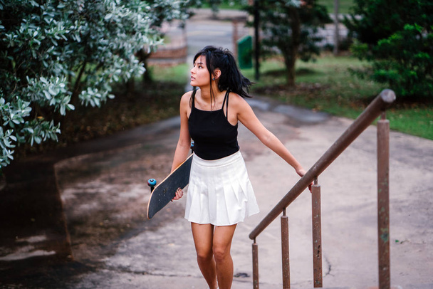 Portrait of Asian Chinese girl with skate in skatepark - Фото, зображення