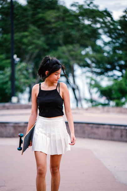 Portrait of Asian Chinese girl with skate in skatepark - Φωτογραφία, εικόνα