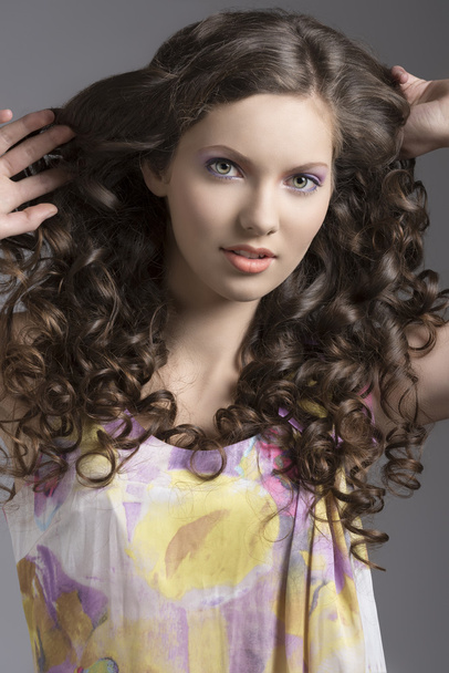 pretty brunette with curly hair smiles - Fotó, kép
