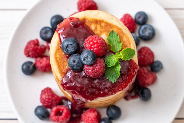 souffle pancake with fresh raspberries and blueberries - Fotó, kép