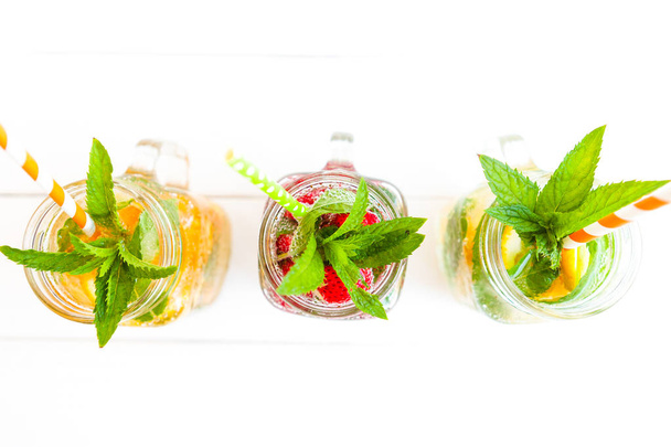 Fresh lemonade with summer fruits and berries on white background - Foto, afbeelding