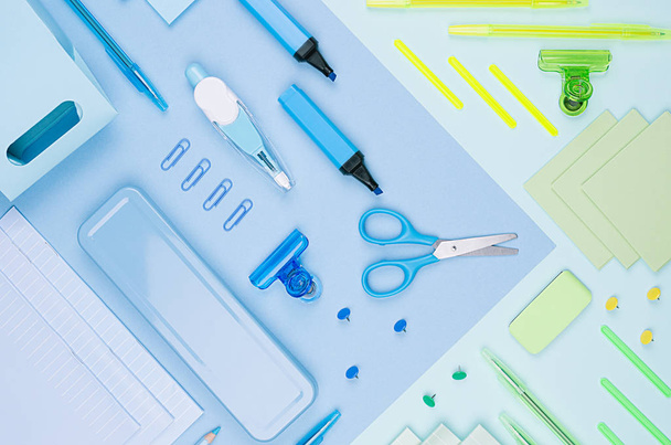 Concept art stationery background for designers - colored office accessories on soft light blue, neon mint backdrop. - Fotó, kép