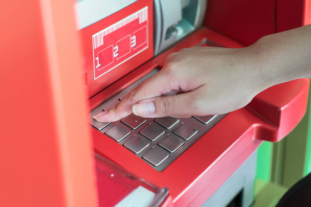 Hand press passwords on ATM bank machine to withdraw money - Zdjęcie, obraz