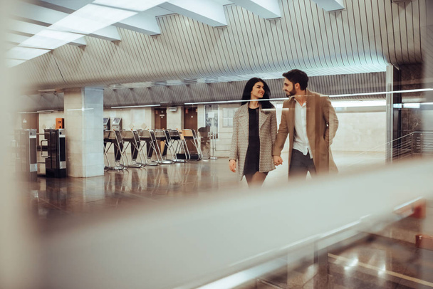 Young romantic couple in subway. Underground love story. - 写真・画像