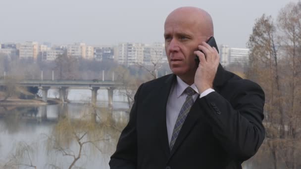 Slow Motion Movie Serious and Confident Businessman Talking to Cellphone - Filmmaterial, Video