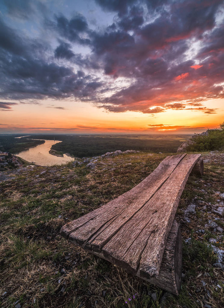 Beautiful Sunset over Lanscape with Danube River. Wooden Bench in Foreground. - Fotoğraf, Görsel