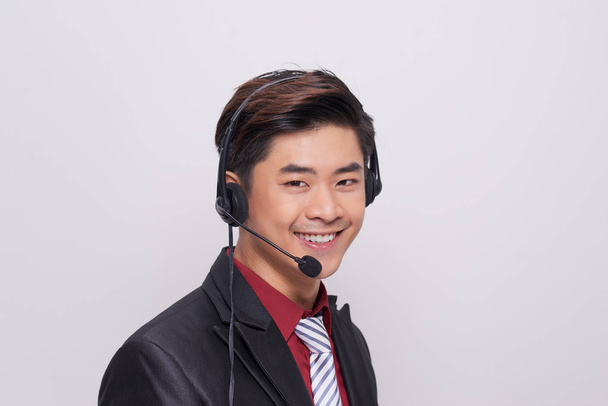 Young asian man in suit wearing a headset - Fotoğraf, Görsel