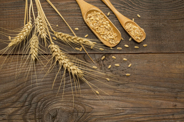 Wheat on wooden background  - Valokuva, kuva