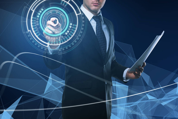 Attractive young european businessman using glowing digital business interface. Future and technology concept - Photo, image