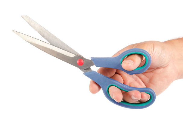 Stationery scissors in hand isolated on white background. - Zdjęcie, obraz