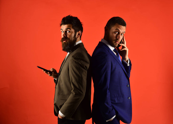 Business conversation concept. Machos in classic suits talk on phone - Photo, Image