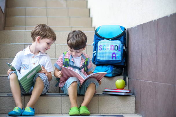 Children go back to school. Start of new school year after vacation. Two Boy friends with backpack and books on first school day. Beginning of class. Education for kindergarten and preschool kids. - Photo, Image