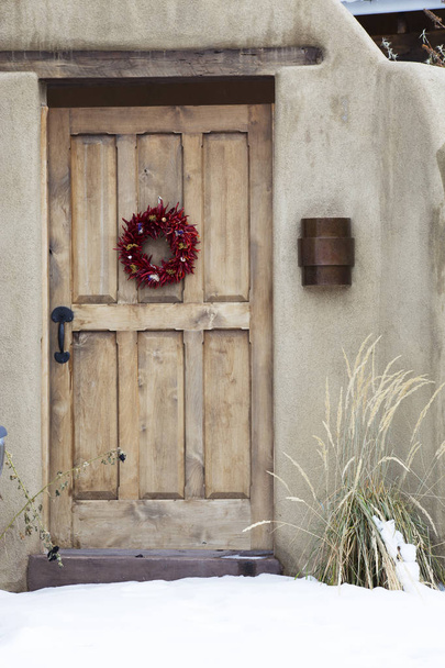 Wooden Entryway with Ristra Wheath in Santa Fe New Mexico
 - Фото, изображение