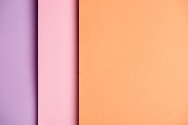 Paper sheets in pink and orange tones background - Foto, afbeelding