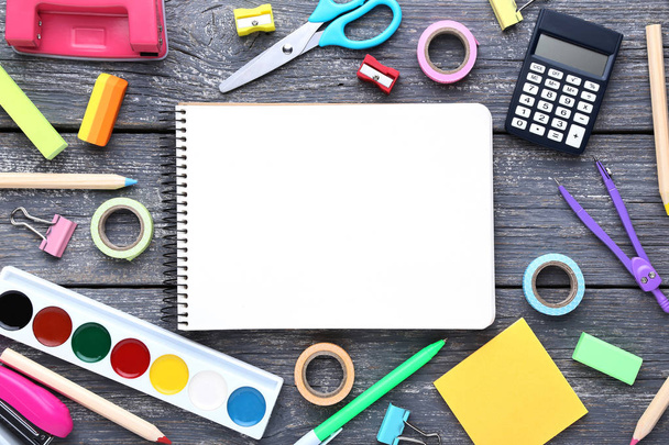 School supplies with blank sheet of paper on wooden table - Foto, Bild