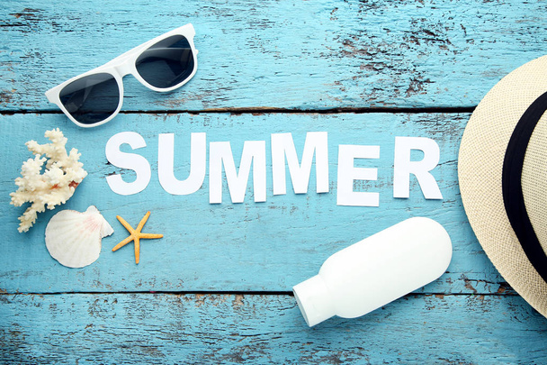 Inscription Summer with seashells and sunglasses on blue wooden table - Φωτογραφία, εικόνα