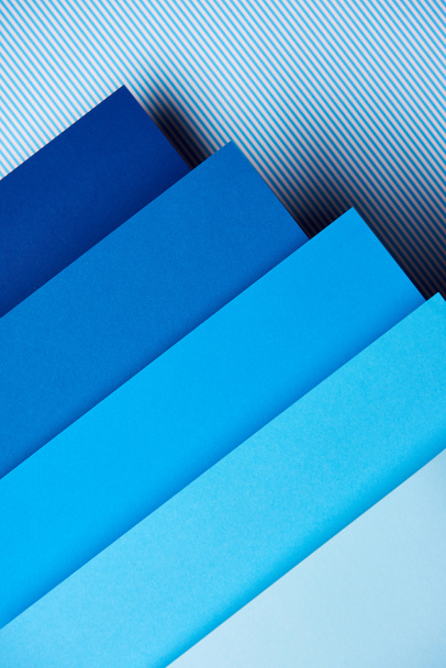 Paper in blue tones on striped background - Photo, Image