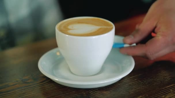 Serve a cup of coffee. Latte art coffee - Felvétel, videó