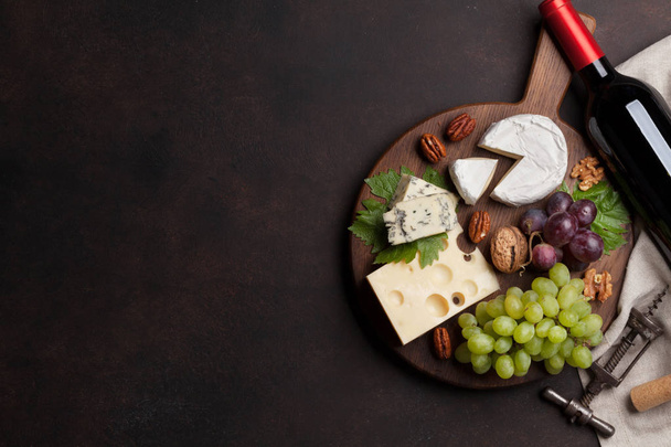 Wine, cheese, grape, bread and nuts. Top view with space for your text - 写真・画像