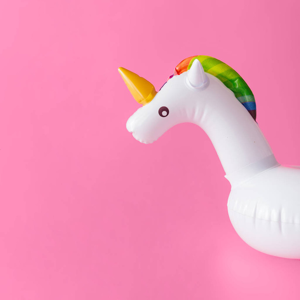 Inflatable unicorn pool toy on pastel pink background, Minimal summer concept  - Photo, Image