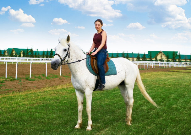 Smiling young girl astride a horse - Fotoğraf, Görsel