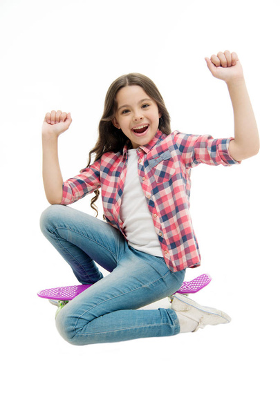 Time to ride. Kid girl excited sits penny board. Modern teen hobby. Girl happy face sit on penny board white background. Originally designed as girls skateboard. Learning how to ride penny board - Foto, imagen