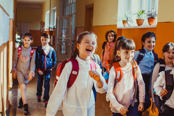 Happy pupils running out of the classroom on summer vacation - Φωτογραφία, εικόνα