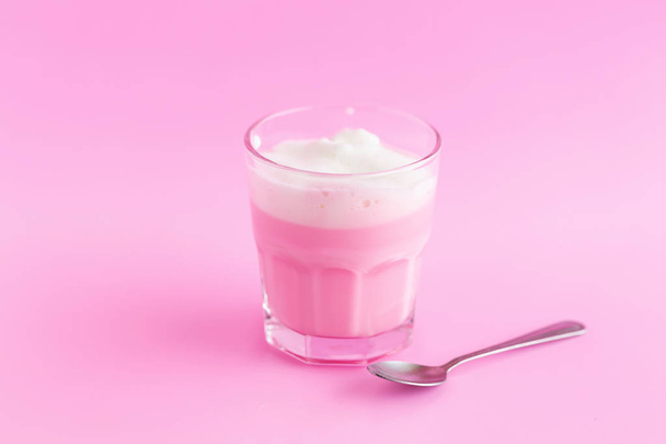 Strawberry milkshake in glass on pink background - Фото, изображение
