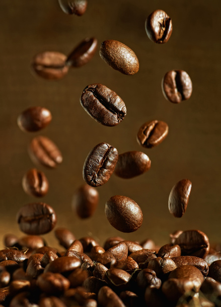 Closeup of coffee beans with focus on one - Photo, Image