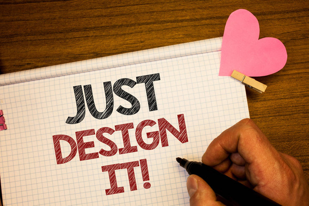 Writing note showing  Just Design It Motivational Call. Business photo showcasing Create New Original Graphics Decorations Man holding pen ideas notebook pink heart letters on wooden background - Photo, Image