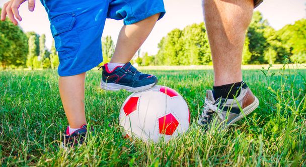 father and son playing with soccer ball  - Фото, зображення