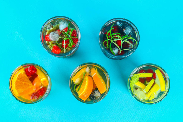 Various detox water in glasses, different tastes, berries, fruits - Photo, image