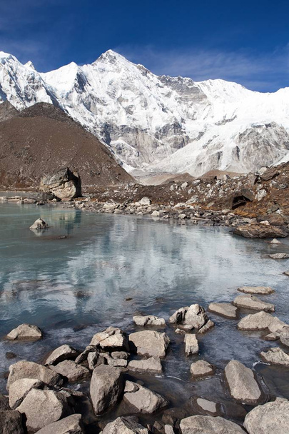 view of Cho Oyu mirroring in lake - Cho Oyu base camp - Everest trek - Nepal Himalayas mountains - 写真・画像
