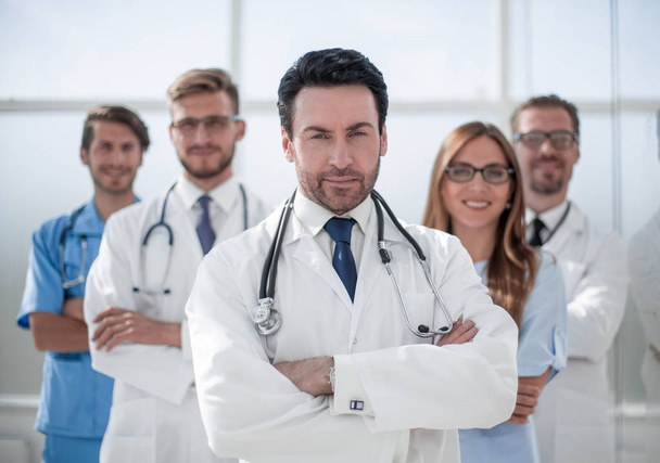confident doctor on the background of colleagues - Foto, Imagem