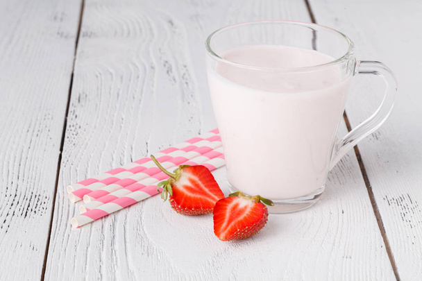 Strawberries and milk drink on white wooden table - Photo, Image