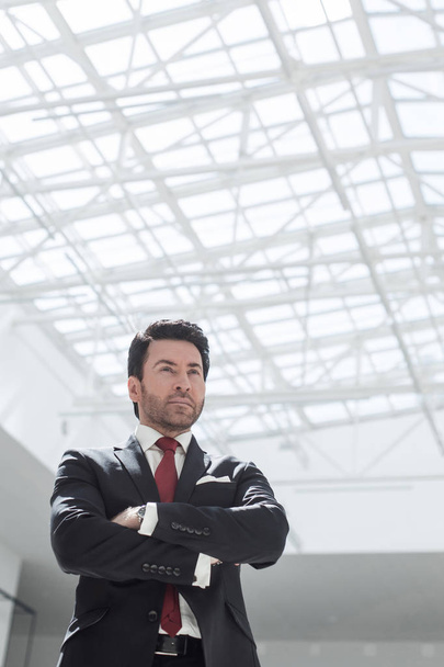confident businessman standing in a spacious office - Photo, Image