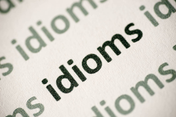word idioms  printed on white paper macro - Photo, Image