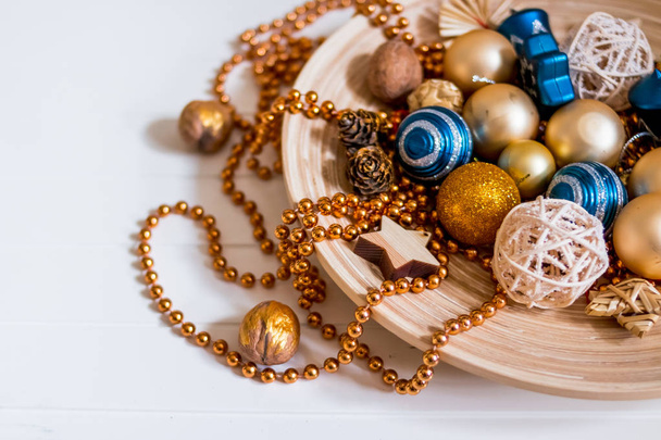 Beads, gold balls. New Year composition.pine cones and Christmas tree decorations on white background. Copy space. Selective focus. - Valokuva, kuva