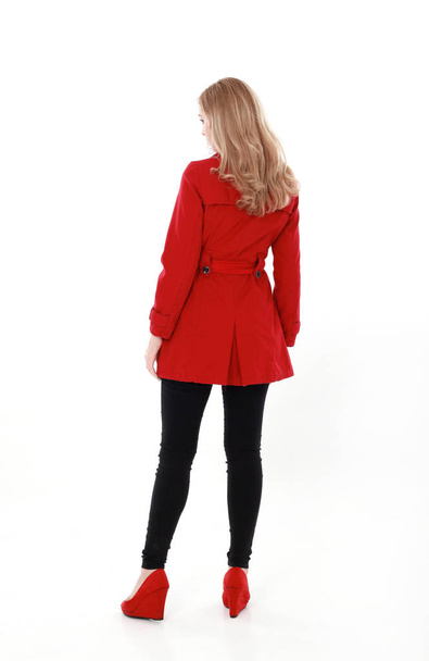 portrait of pretty blonde girl wearing red trench coat, full length standing pose.. isolated on white studio background. - Fotografie, Obrázek