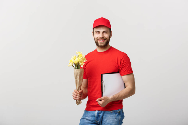 Portrait of happy flower delivery man holding clipboard on white background - Photo, Image