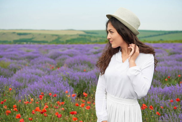 young girl is in the lavender field, beautiful summer landscape with flowers - Photo, Image