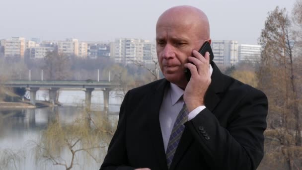 Businessman Talking to Cellphone Waiting a Meeting Outside Office Building - Footage, Video