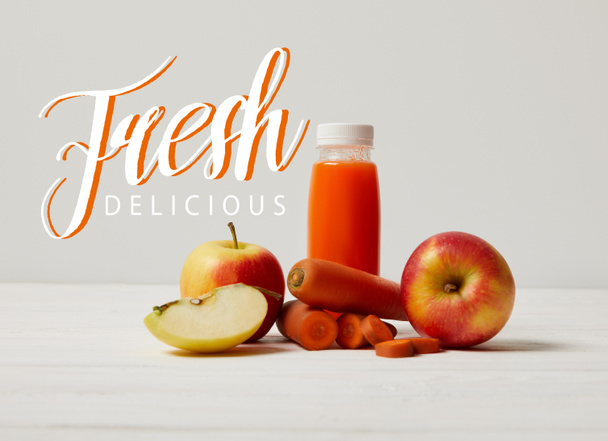 detox smoothie with apples and carrots on white wooden surface, fresh delicious inscription - Zdjęcie, obraz